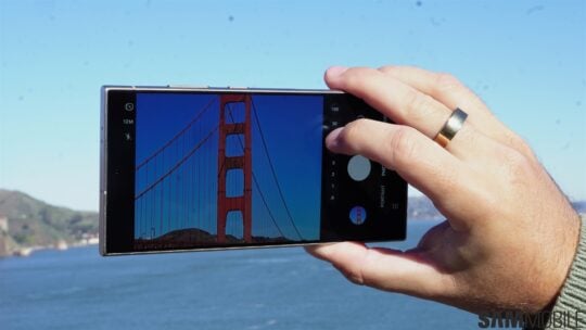 a person taking a picture of a bridge